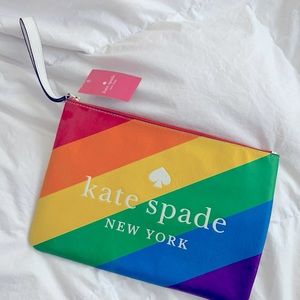 Kate Spade clutch with zipper closure and a wrist strap. Rainbow and white.
